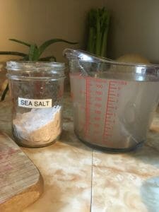 jar of sea salt and a glass measuring cup