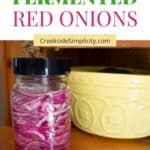 Pinterest pin - Easy Fermented Red onions showing a jar of red onions next to a bright yellow fruit bowl