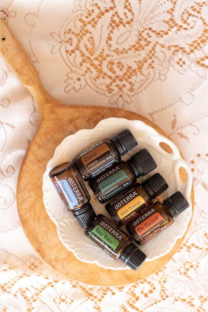 doTERRA essential oils on a white plate, on a wooden board