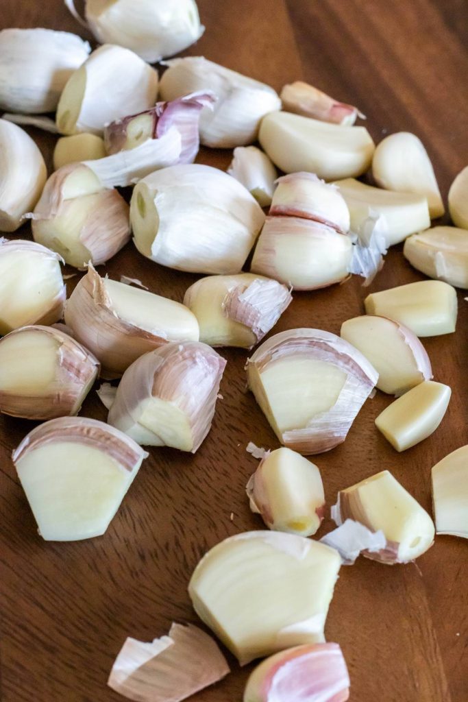 individual garlic cloves with root and tip sliced off