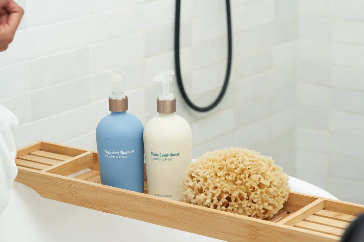 bottle of shampoo & conditioner in a bath tub